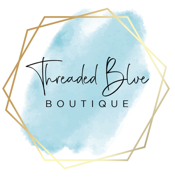Logo with gold hexagon frame blue paint brush stroke and the words Threaded Blue Boutique.