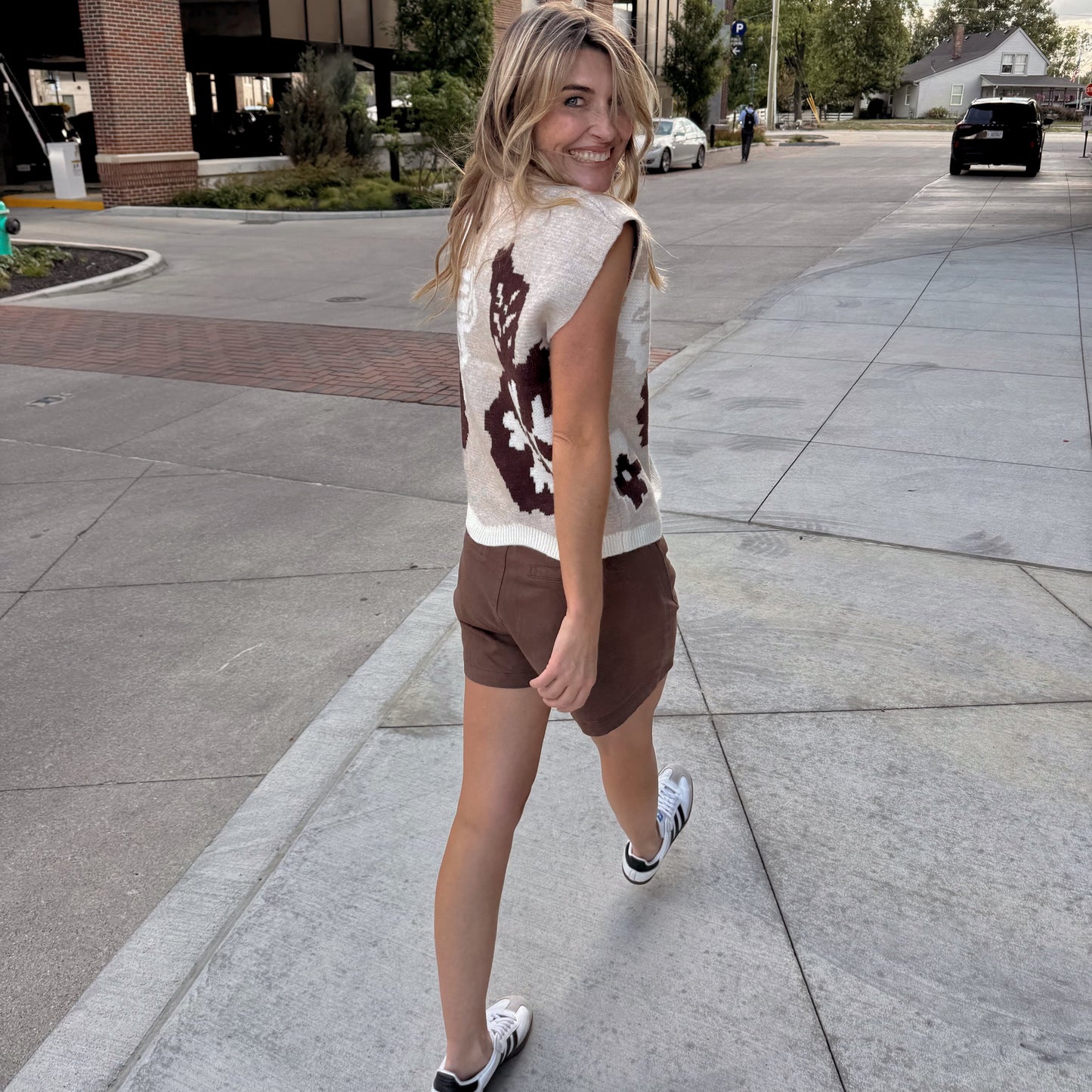 Person walking on a sidewalk in an urban setting
